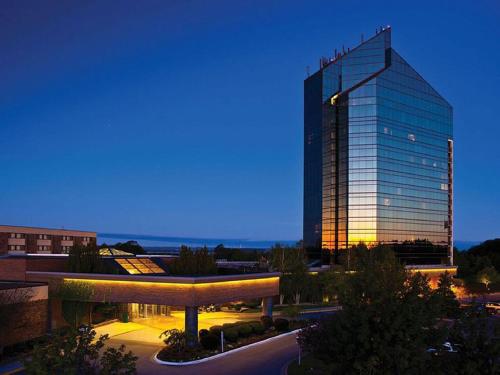 a tall glass building in a city at night at Driftwood Dreams 1B in Traverse City