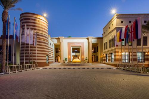 a large building with flags in front of it at Marina Resort Port Ghalib, a member of Radisson Individuals in Port Ghalib