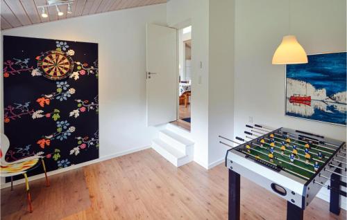 a room with a foosball table and a dart board at Holiday Home Eneb in Dagstrup