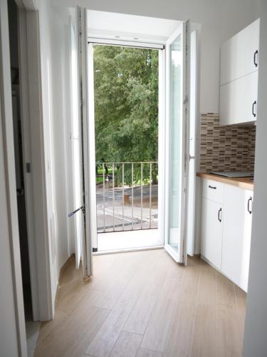 a kitchen with an open door to a balcony at Porta Venosina Luxury House - WiFi e Netflix gratis in Melfi