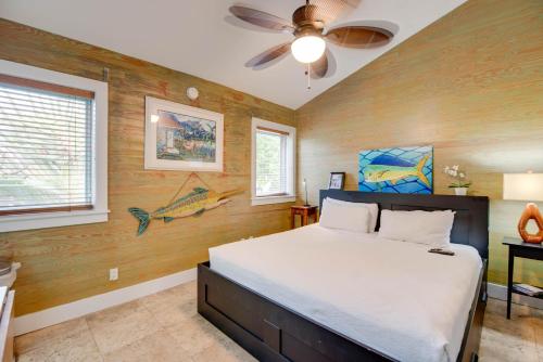 a bedroom with a bed and a ceiling fan at Pescado Penthouse in Key West