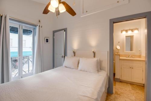 a bedroom with a white bed and a window at Yellowfin Ledge in Key West