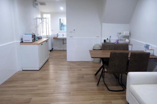 a kitchen and dining room with a table and a counter at Oskar's House in Bangkok