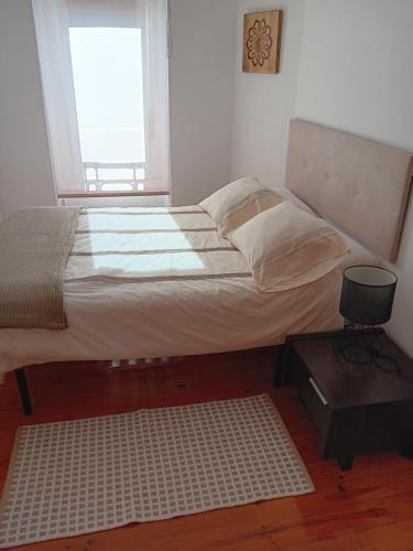a bedroom with a large bed with a window at Casa Regina Baiona ideal familias Peregrinos y parejas, cerca del camino y de la playa in Baiona