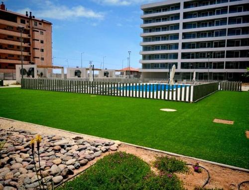 a large artificial lawn in front of a building at Terrazas del sol IV in La Serena