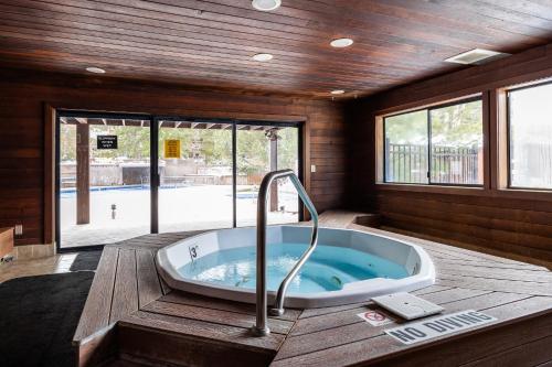 a bath tub in a room with a pool at Walk to Lift, Sleeps 6, Shared Hot Tub, Cozy Interiors, Gourmet Dining, Fireplace and Patio in Park City