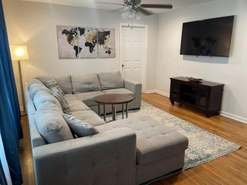 a living room with a couch and a table at Charming 3-bedroom Home -Quiet East Atlanta Neighborhood in Atlanta