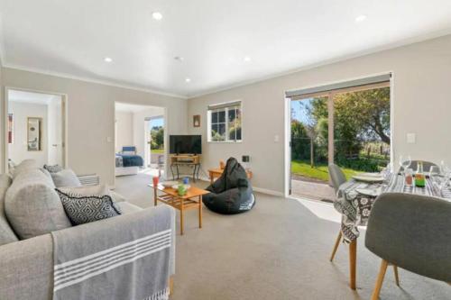 a living room with a couch and a table at Grace Cottage in Turangi