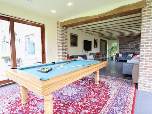 a living room with a pool table at Les Charmes in Chevron