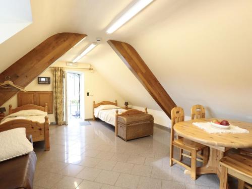 a bedroom with a bed and a table in a room at Les Charmes in Chevron