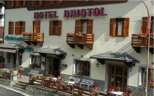 a hotel building with tables and chairs in front of it at Hotel Bristol in Fiumalbo