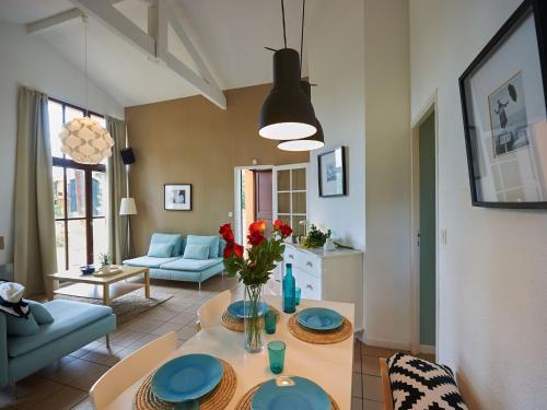 a living room with a table with blue plates on it at Villa in France with Private Garden in Salles