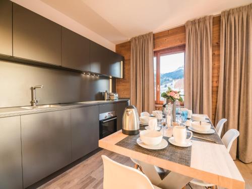 une cuisine et une salle à manger avec une table et des chaises dans l'établissement Chalet in Megève with Mont-Blanc Views, à Praz-sur-Arly