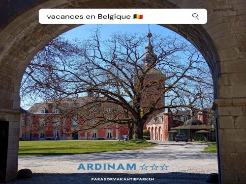 an archway with a tree in front of a building at Glamping Lodge in the Ardennes in Olloy-sur-Viroin