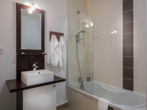 a bathroom with a sink and a shower and a tub at Apartment in Les Eyzies near Font-de-Gaume in Les Eyzies-de-Tayac