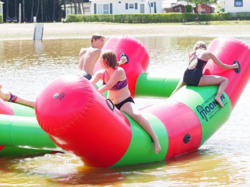 a group of people riding on inflatables in the water at Chalet in Breebos near Antwerpse Noorderkempen in Rijkevorsel