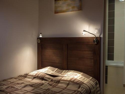 a bedroom with a bed with a newspaper on it at Apartment in Les Eyzies near Font-de-Gaume in Les Eyzies-de-Tayac
