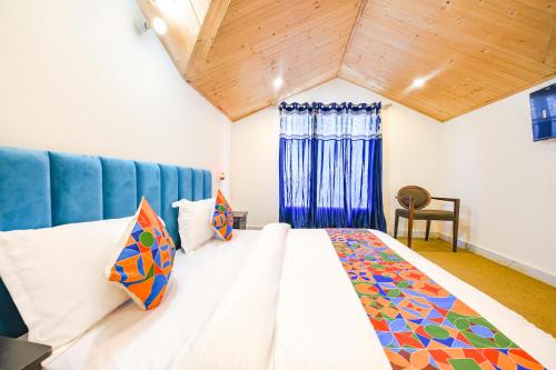 a bedroom with a large bed with a blue headboard at The GingerGrass in Shimla
