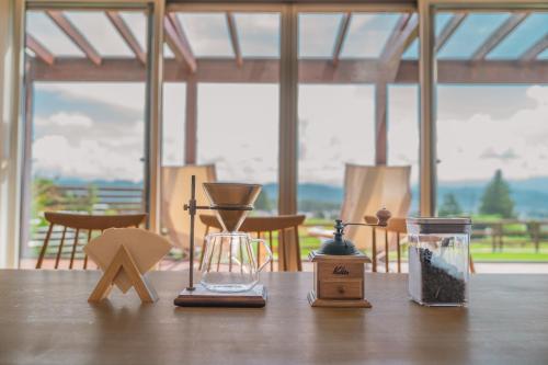 a wooden table with some items on top of it at 一棟貸切Azumino36Stay 安曇野の静かな隠れ家 貸切サウナ BBQ 絶景テラス in Azumino