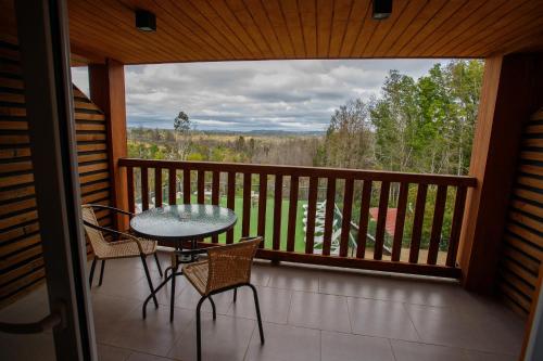 a patio with a table and chairs on a balcony at Aguas del Monte Hotel&Spa in Tomé