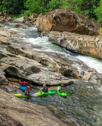 a group of people in kayaks on a river at Sítio Flor das Águas in Lumiar