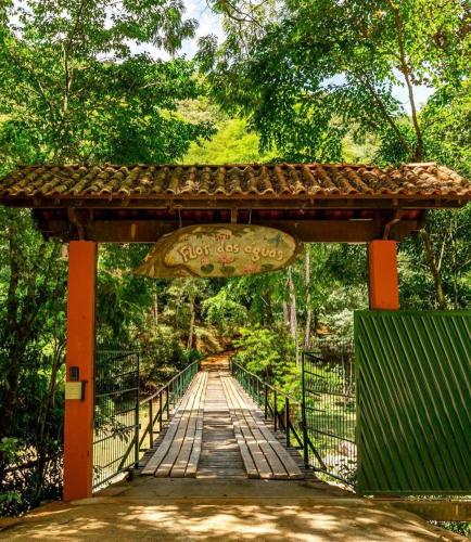a bridge in a park with a sign on it at Sítio Flor das Águas in Lumiar