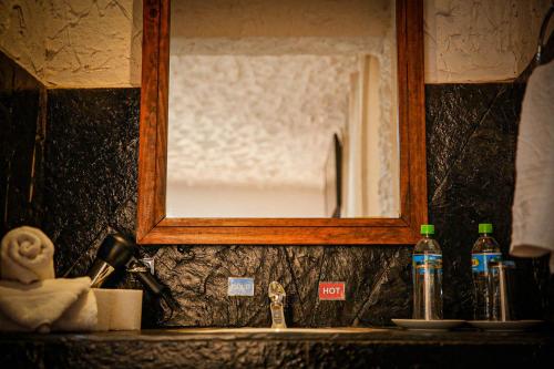 a bathroom sink with a mirror above a sink at KW HOTEL in Uyuni