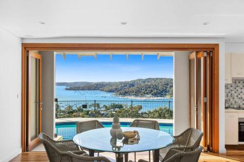 a dining room with a table and a view of the ocean at Sea La Vie at Bayview - 'paradise by the sea' in Bay View