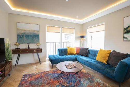 a living room with a blue couch and a table at York Central No 1, within the city walls, free parking in York