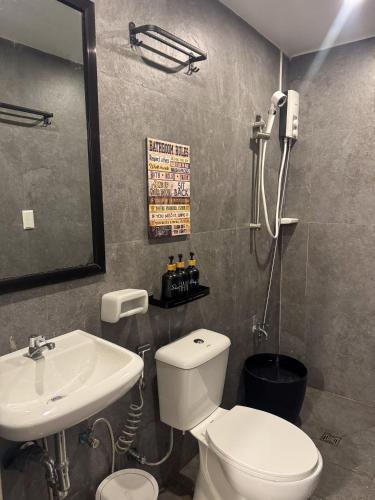 a bathroom with a white toilet and a sink at Glass Cabin Secluded Overlooking Oasis with pool in San Jose del Monte