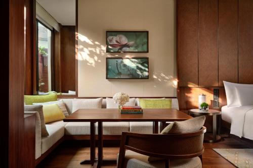 a living room with a table and a couch at Grand Hyatt Singapore in Singapore
