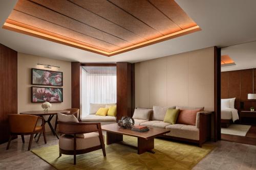 a living room with a couch and a table at Grand Hyatt Singapore in Singapore