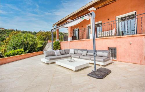 a couch on a patio in front of a building at Stunning Home In Les Adrets-De-L'estére in Les Adrets de l'Esterel
