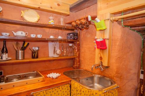 a kitchen with a sink and a counter top at Arzipreste IV La Casita del Jardín in León