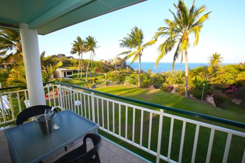 a balcony with a table and a view of the ocean at Whitsunday Sands Resort in Bowen