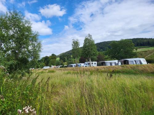 a field of tall grass with tents in the background at Apartment in Luxembourg near Scenic Views in Ingeldorf