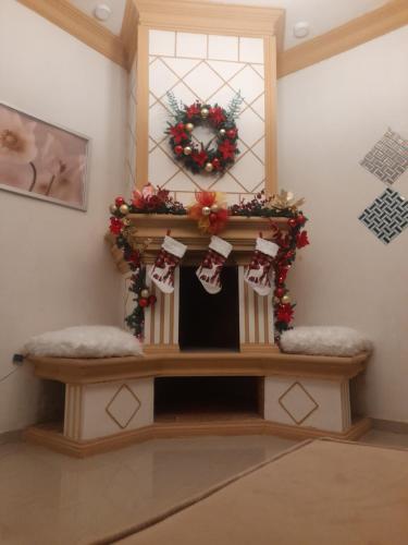a room with a fireplace with christmas decorations on it at Cerca del divino niño I WiFi I TV in Constanza