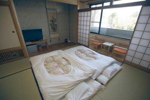 Una cama o camas en una habitación de KIMIEN Hotel