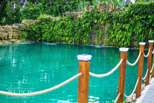 a pool of blue water with a rope around it at Lake Of Dreams Miami House in Miami