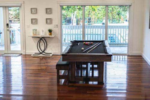 a pool table in the middle of a room at Lake Of Dreams Miami House in Miami