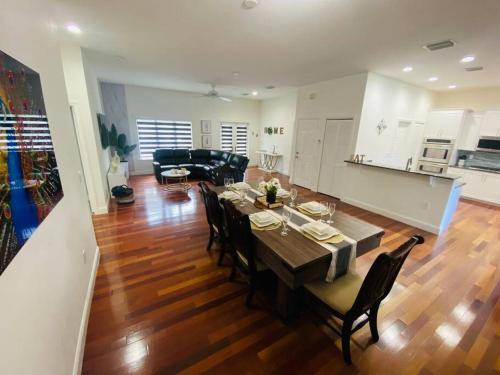a dining room and living room with a table and chairs at Lake Of Dreams Miami House in Miami