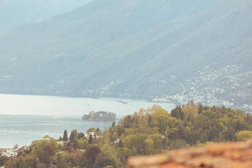 a view of a body of water with a mountain at Casa Teatro Panoramico 5 Star Holiday House in Locarno