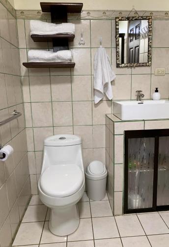 a bathroom with a toilet and a sink at Caladium House in the best weather! in Mercedes