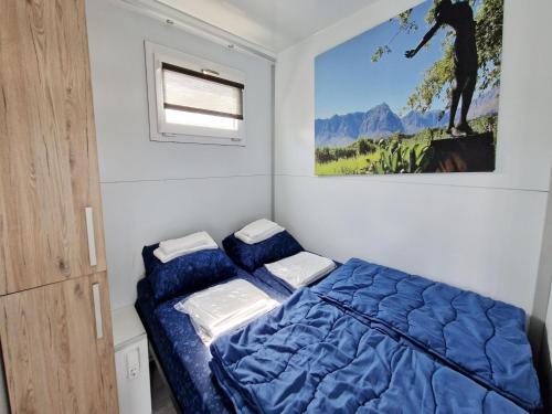 a bedroom with a bed and a painting on the wall at Water Lodge in Naarden with Marina Views in Naarden