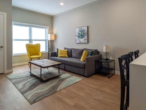 a living room with a couch and a yellow chair at 221 Modern 1BR Apt Walk to NJT in Dunellen