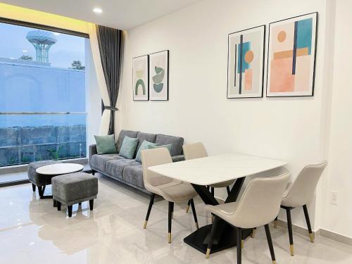 a living room with a table and a couch at DOME APARTMENT in Nhơn Trạch