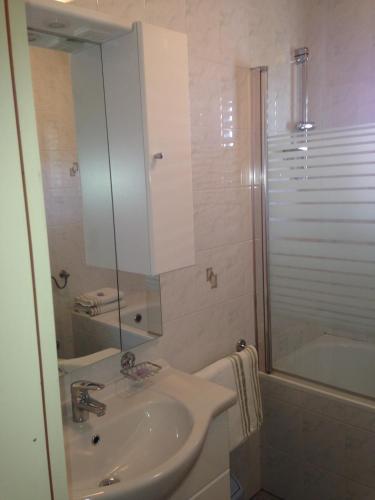 a bathroom with a sink and a shower and a tub at Apartments Villa Kristina in Pula