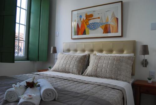 a bedroom with a bed with towels on it at Pousada Bahia Pelô in Salvador