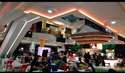 a group of people sitting at tables in a restaurant at Habitación 4 en Casa Retro in Medellín