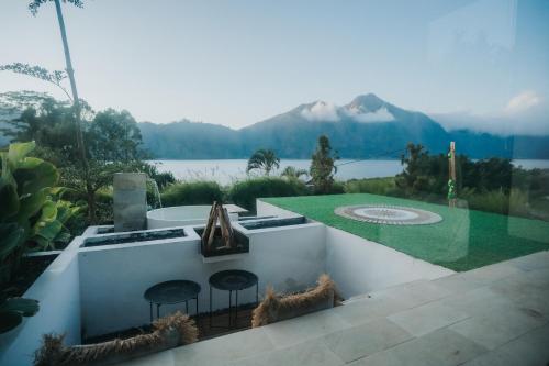 a patio with a view of a lake and mountains at Skylake Villa in Kubupenlokan